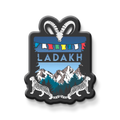 Fridge magnet with mountain and leopard design featuring the word 'Ladakh'.