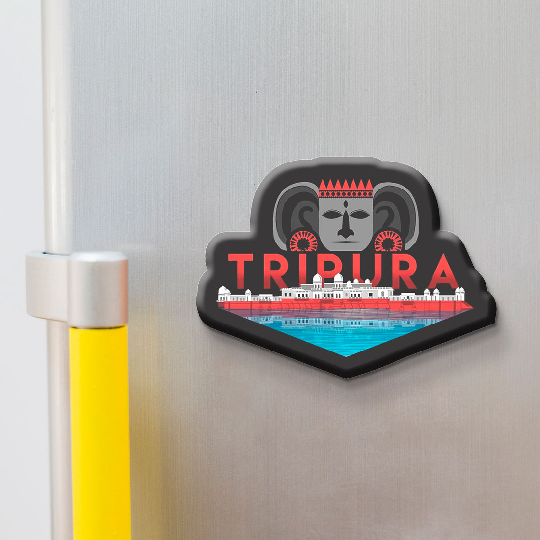Fridge magnet with 'TRIPURA' design on a metallic surface
