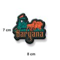 Decorative 'Haryana' logo magnet on a refrigerator door