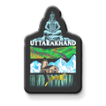 Fridge magnet with 'Uttarakhand' design featuring a mountain, house, and nature on a metallic surface.