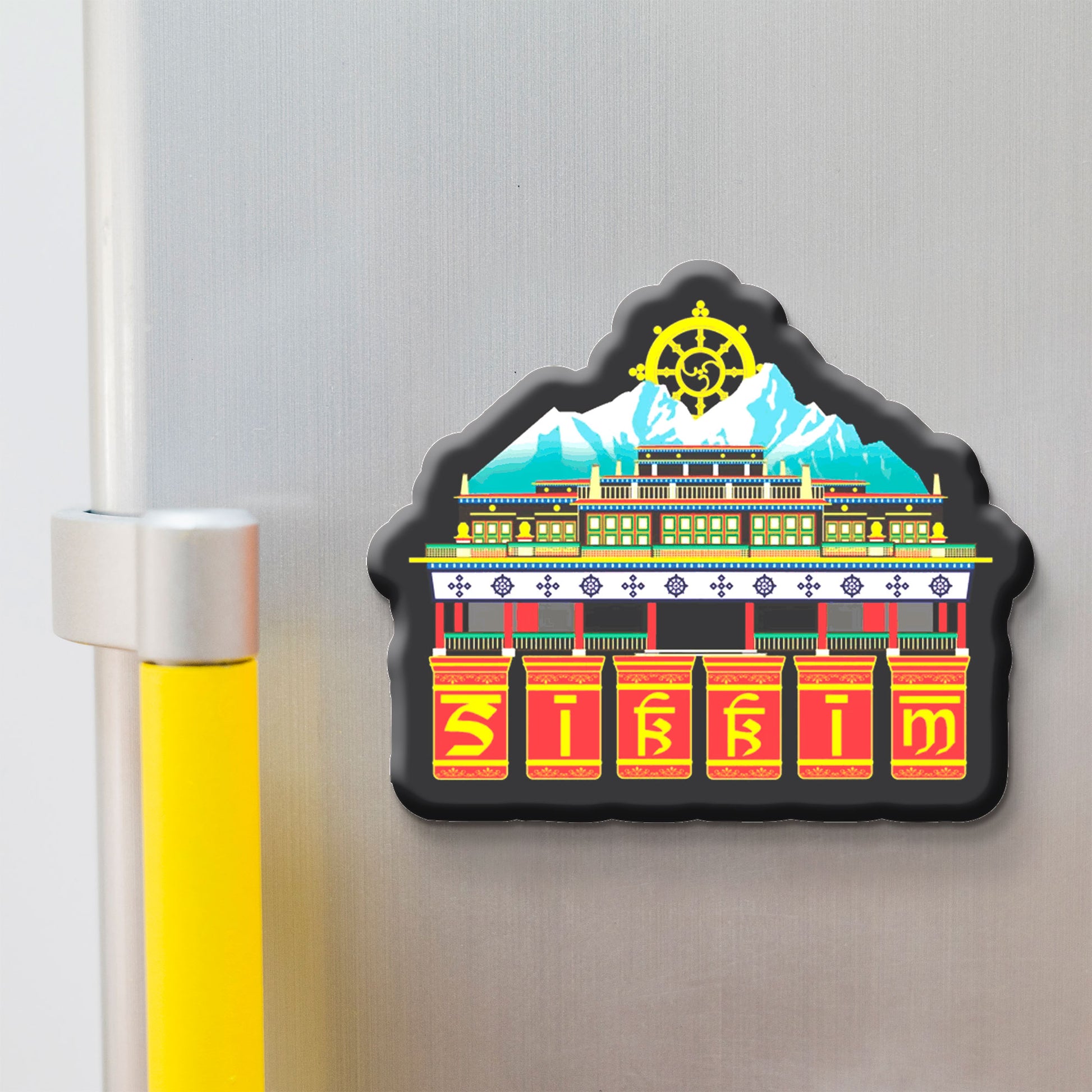 Decorative skkim magnet with a colorful design of a building and a mountain on a refrigerator.