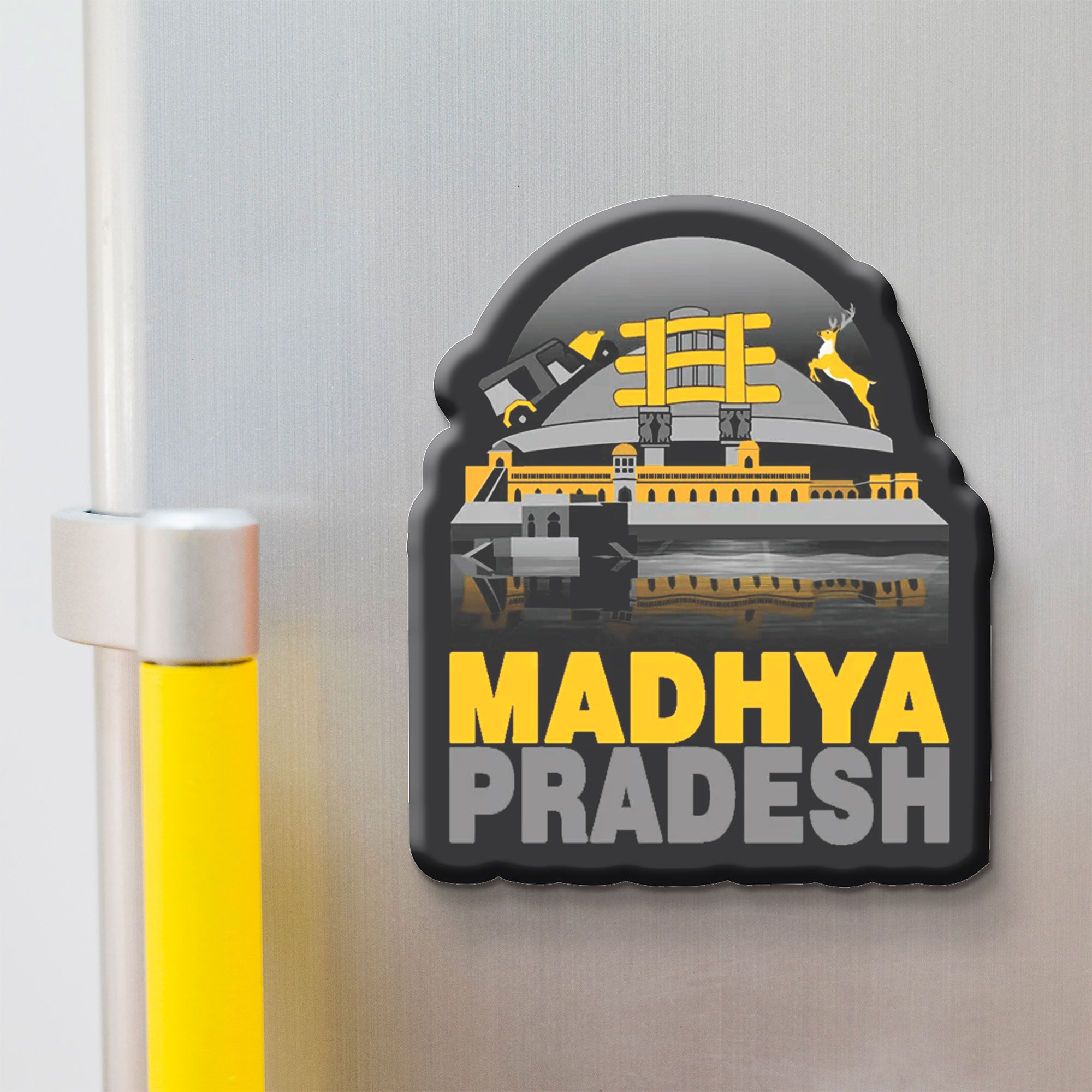 Fridge magnet with 'Madhya Pradesh' text and architectural design on a metallic surface.
