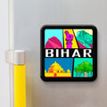 Fridge magnet with colorful design of Bihar landmarks on a metallic surface.