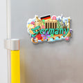 Fridge magnet with German-themed design on a refrigerator